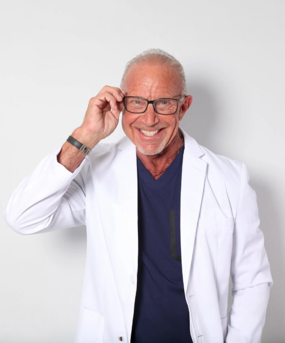Dr. Larry Rifkin, smiling, in a white coat